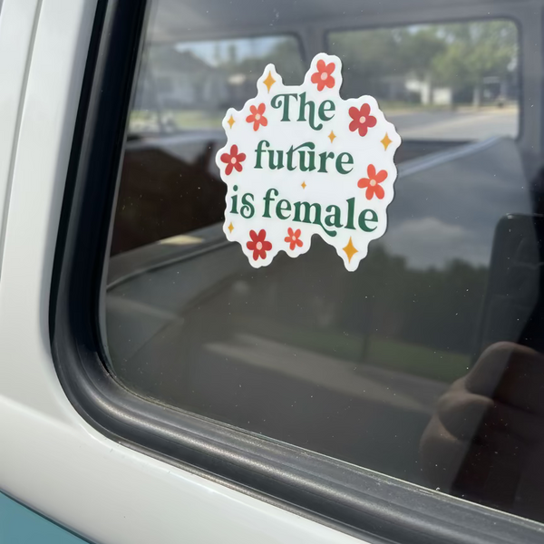 Sticker with 'The future is female' text on a car window